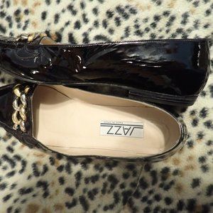 black patent genltly used flats with gold hardware chain. 10